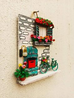 a small window with flowers on it and a bike parked in the window sill