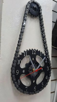 a clock made out of gears hanging on the wall