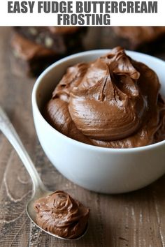 a bowl filled with chocolate frosting next to a spoon