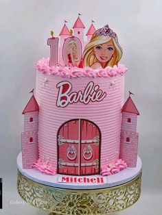 a barbie doll birthday cake with pink icing