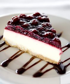 a piece of cheesecake on a plate with chocolate sauce