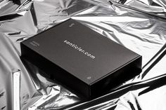 a black box sitting on top of silver foil