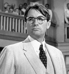 black and white photo of man in suit with glasses