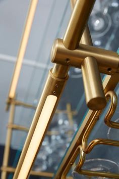 a close up of a metal rack with wine glasses in it's glass holders