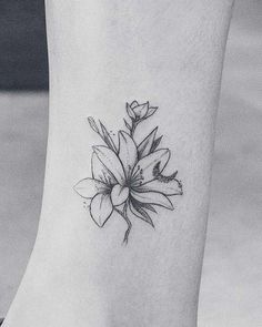 a black and white photo of a flower on the ankle