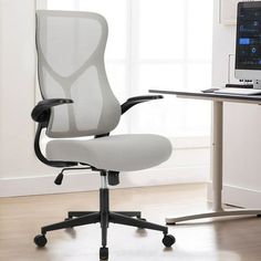 an office chair sitting in front of a computer desk