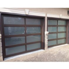 two brown garage doors in front of a house