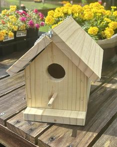 a bird house sitting on top of a wooden table