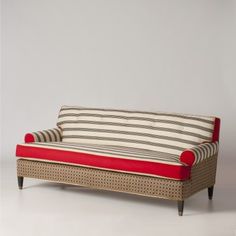 a red and white striped couch sitting on top of a table