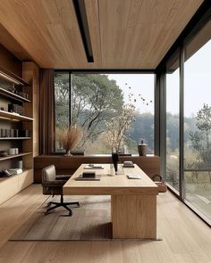 a wooden table sitting in front of a large window