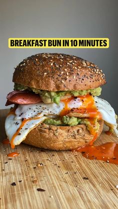 an egg, bacon and avocado sandwich with the words breakfast bun in 10 minutes