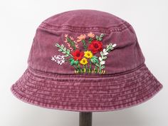 a purple bucket hat with flowers on it