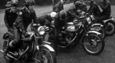 black and white photograph of men on motorcycles