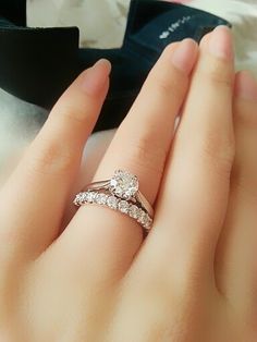 a close up of a person's hand with a ring on their finger