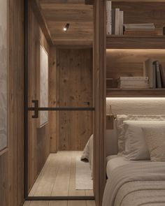 there is a bed in the room with wooden walls and shelves on either side of it