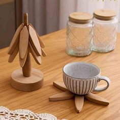 wooden spoons and cups on a table with doily