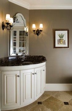 a bathroom with a sink, mirror and two lights on the wall next to it