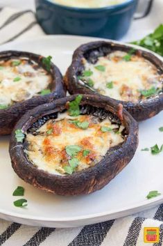 three stuffed mushrooms on a plate with parsley