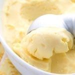 a bowl filled with ice cream next to a spoon