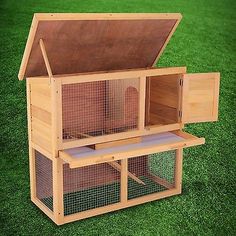 a large wooden bird house with two birds in it's nesting box on the grass