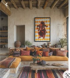 a living room filled with lots of furniture next to a painting on the wall over a fire place