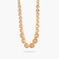 Long necklace with a row of round faceted glass stones in apricot tones, gold-plated brass mounting.The Diamantine, a bespoke faceted glass must-have, is proof of Les Néréides' expertise in high-end costume jewelry. Pair it with the other jewels from the collection to create a matching set. Necklace: Gold-plated brass, hand-enameled and cut glass Length: 65cm Width: 1.5mDepth: 0.8cm Weight: 54.3g ALL SALE ITEMS ARE FINAL SALEAMSO210/1 AMSO210/1 Les Nereides, Set Necklace, Crystal Stones, Necklace Necklace, High Fantasy, Brass Frame, Faceted Glass, Faceted Crystal, Cut Glass