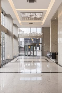 an empty lobby with marble floors and walls