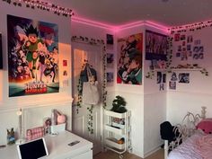 a bedroom with posters on the wall and desk