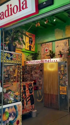 a store front with many pictures on the wall and signs above it that read radiola