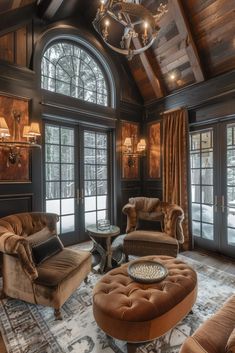 a living room with couches, chairs and chandelier in the middle of it