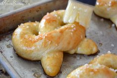 two doughnuts sitting on top of a baking pan