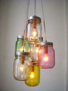 mason jar chandelier with lights hanging from it's sides in various colors