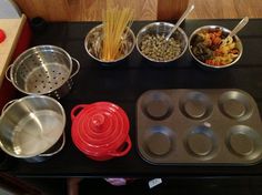 an assortment of cooking utensils and pans on top of a black stove