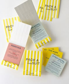 several pieces of yellow and white striped paper with different types of stickers on them