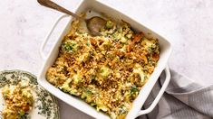 a casserole dish with broccoli, cheese and bread crumbs