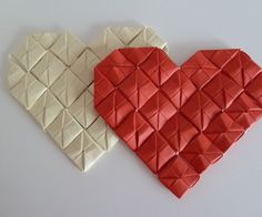 two pieces of origami in the shape of a heart