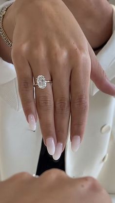 a close up of a person's hand wearing a ring