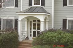 a house with white trim and black shutters