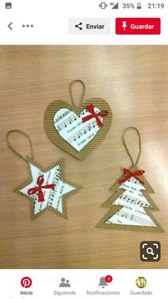 three wooden christmas ornaments with red bows and tags attached to them, on a table