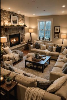 a living room filled with furniture and a fire place in the middle of the room