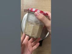 someone is holding a jar with something in it