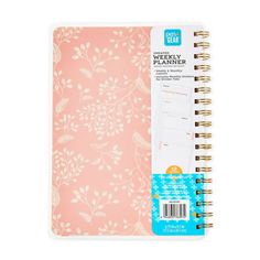 a pink notebook with white flowers on it