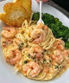 a white plate topped with pasta and shrimp