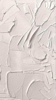 white paint is being applied on the wall in an artistic manner with various shapes and sizes