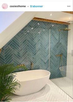 a white bath tub sitting under a bathroom window next to a green leafy plant