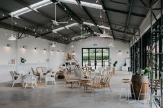 a large room with tables and chairs inside of it, surrounded by glass walls that are open to the outside