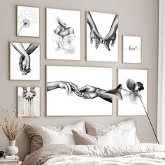 a bed with white sheets and pictures on the wall above it that have hands holding each other