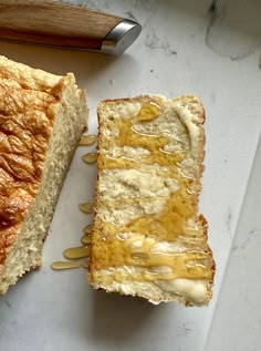 two pieces of bread sitting on top of a cutting board