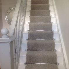 a set of stairs with carpet on the bottom and handrails to the top