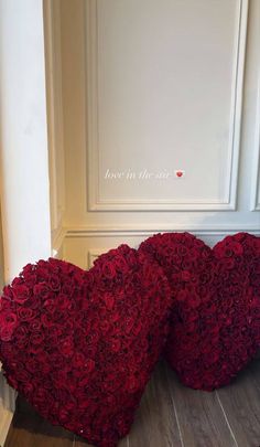 two heart shaped red roses sitting on the floor